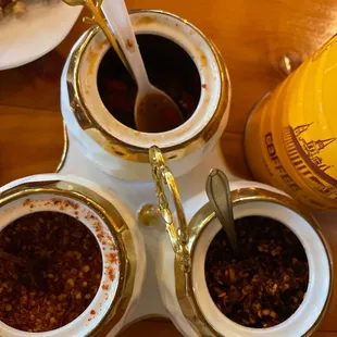 All the spices for your enjoyment (fish sauce with slices of fresh Thai chili peppers, pepper flakes, or roasted pepper flakes)