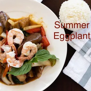 a plate of food with shrimp, eggplant, and rice