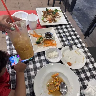 Pork pad se ew, orange chicken with rice, gyozas, large Thai tea