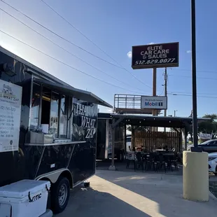 a food truck parked in front of a restaurant