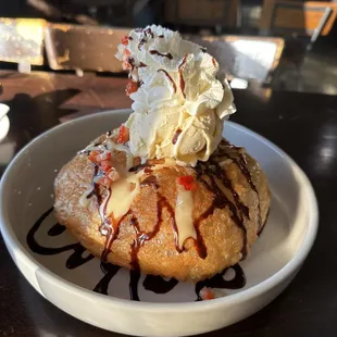 The bomb: crispy fried roti filled with banana and strawberries topped with a scoop of vanilla ice cream and some whipped cream
