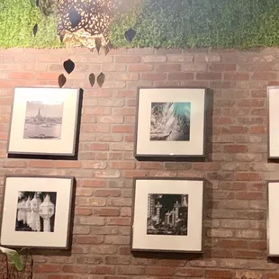a brick wall with pictures on it