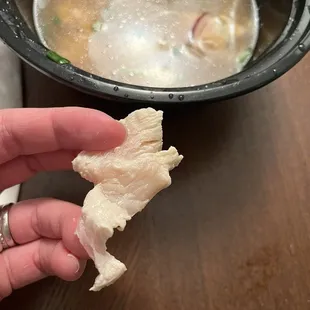 Raw chicken in cooked pho
