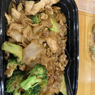 chicken and broccoli in a black container