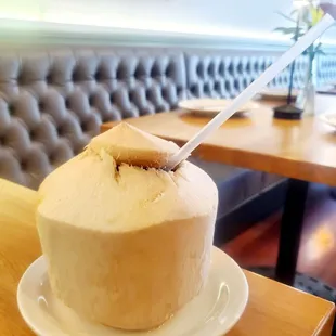 Coconut + vodka + triple sec cocktail ~ The best part is digging out the Coconut after you've finished the cocktail!