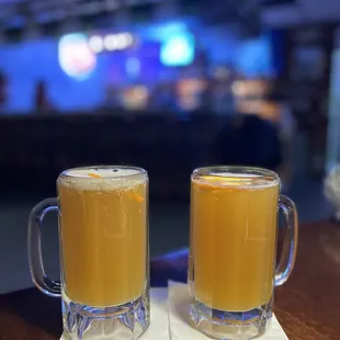 two mugs of beer on a table