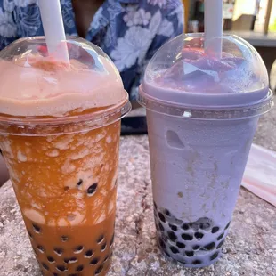 Thai tea smoothie with boba and taro smoothie with boba.