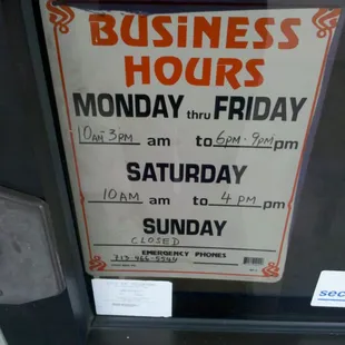 a business hours sign on a glass door