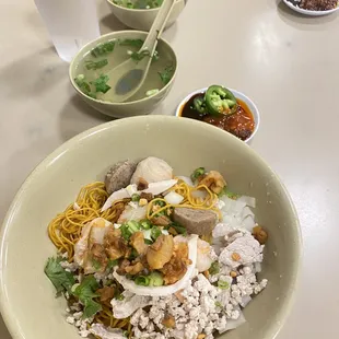 a bowl of noodles with meat and vegetables