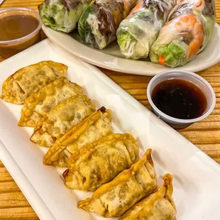 a plate of vegetable rolls and dipping sauce