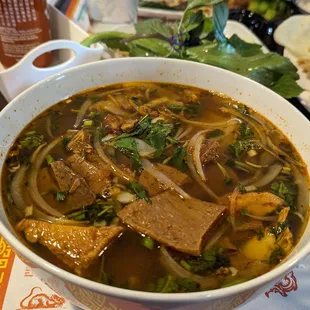 Spicy Veggie Beef Noodle (Bún Bò Huế)  Big rice noodles,veggies beef,tofu,Mushroom veggie ham and fresh vegetables.