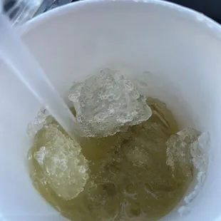 Chunks of ice to the top of the cup for sugarcane drink.