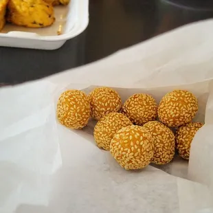 Tiny sesame balls. 4pcs $1.00 so crispy and crunchy! They make it fresh, and people buy more than one order because it&apos;s a snack on Crack