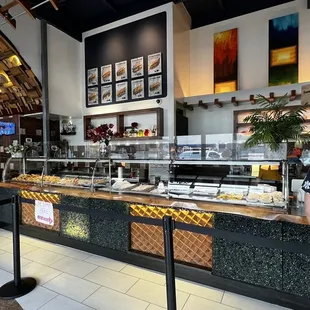 a woman standing in front of a buffet