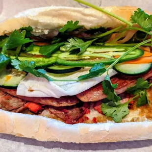 a hand holding a sandwich