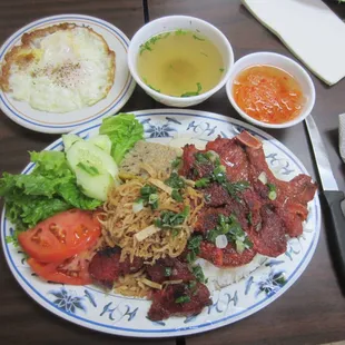 Com dac biet (or &quot;com suon, bi, cha&quot; on menu) - rice with pork chop, pork skin, meatloaf, veggies, broth, fish sauce, egg.