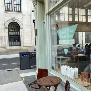 a table and chairs in front of a window