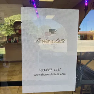 a sign in the window of a coffee shop