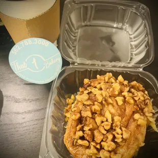 Cinnamon roll with walnut topping and hot latte