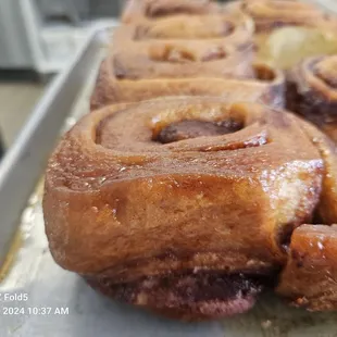 The signature cinnamon roll in the warm caramel pan just waiting to be scooped up and drizzled with icing