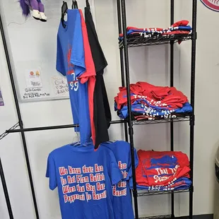 a shelf of t - shirts