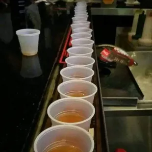 a row of cups of beer
