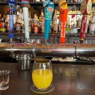a glass of orange juice on the bar