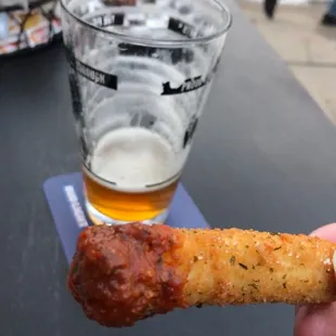 a hand holding a piece of food