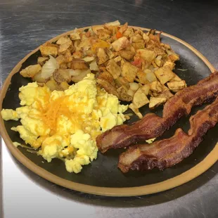Traditional Breakfast with Bacon, Eggs with Cheese HomeFries include onions and peppers