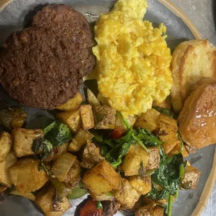 Veggie patties, scrambled eggs with cheese, biscuit, home, fries, onions, peppers, spinach