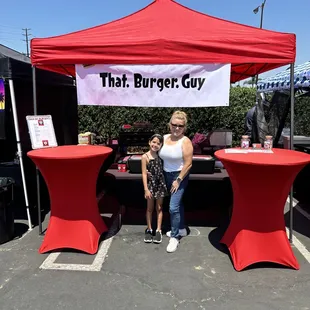 a woman and a child under a tent