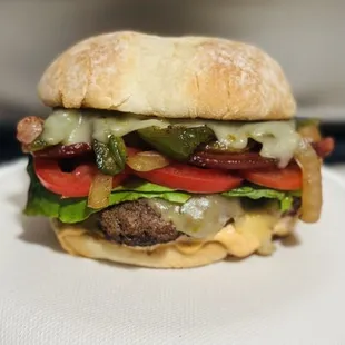 The OG Burger, bacon, grilled onions, grilled jalapeños, chipotle mayo, pepper Jack cheese, lettuce and tomato.