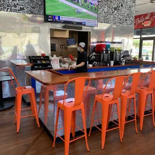 ws a bar with orange chairs