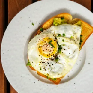 Jalapeno Avocado toast crowned with a fried egg