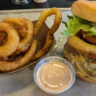 Gouda bacon cheeseburger with onion rings on the side