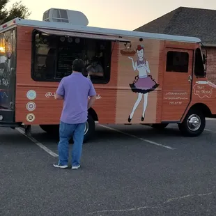 a man standing in front of a food truck