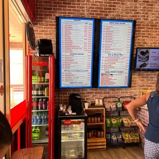 a woman standing in front of a menu