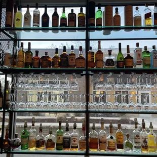 a shelf full of liquor bottles