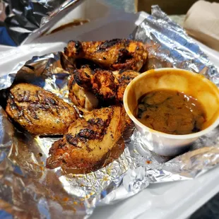 Smoked wings with teriyaki garlic sauce on the side.
