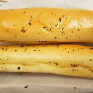 two breadsticks on a piece of paper