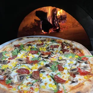 Garden with pepperoni all Day firewood pizza