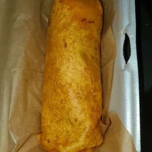 a burrito wrapped in wax paper