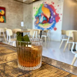 a drink in a glass on a wooden table