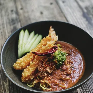 a bowl of food on a wooden table