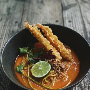 a bowl of food on a wooden table