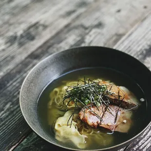 a bowl of soup on a wooden table