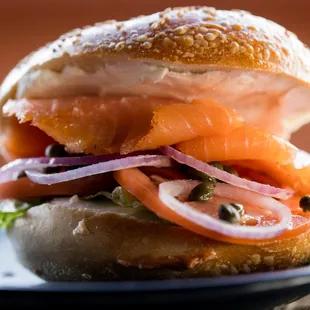 a bagel sandwich with salmon and onions