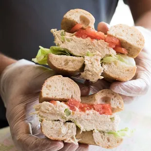a person holding a sandwich