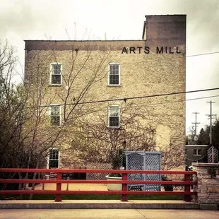 a brick building with a sign that says arts mill
