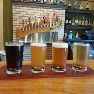 a flight of beers on a bar